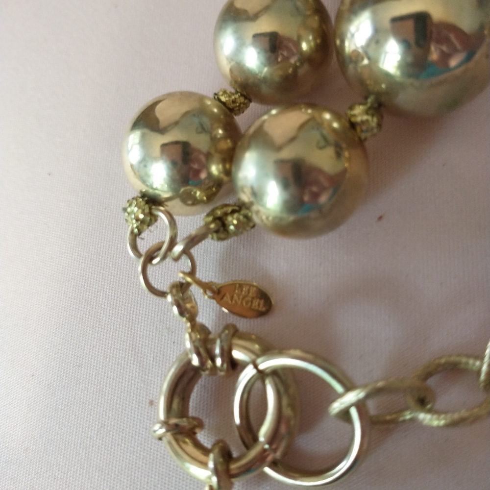 LEE ANGEL NECKLACE GOLD BALLS WITH RHINESTONES IT IS KNOTTED BETWEEN EACH BAL